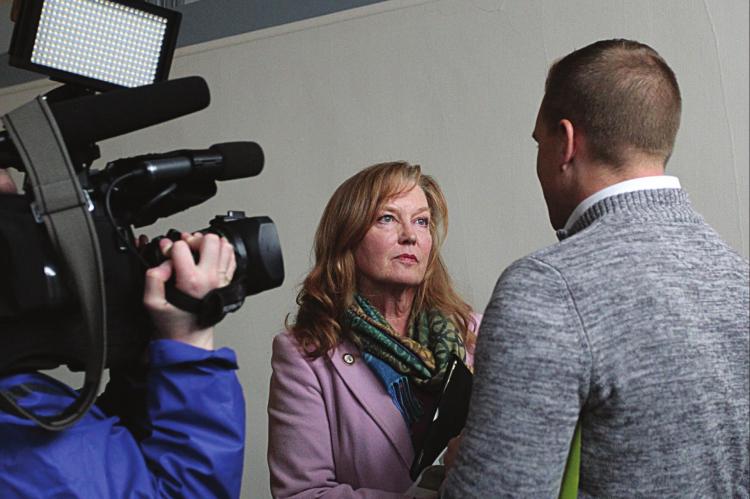 AFTER ANOTHER contentious meeting in February, Ray County Eastern Commissioner Luann Ridgeway answers questions for one reporter, but not others waiting to answer questions in the same hallway in the Clay County Administration Building on the Liberty Square. ‘