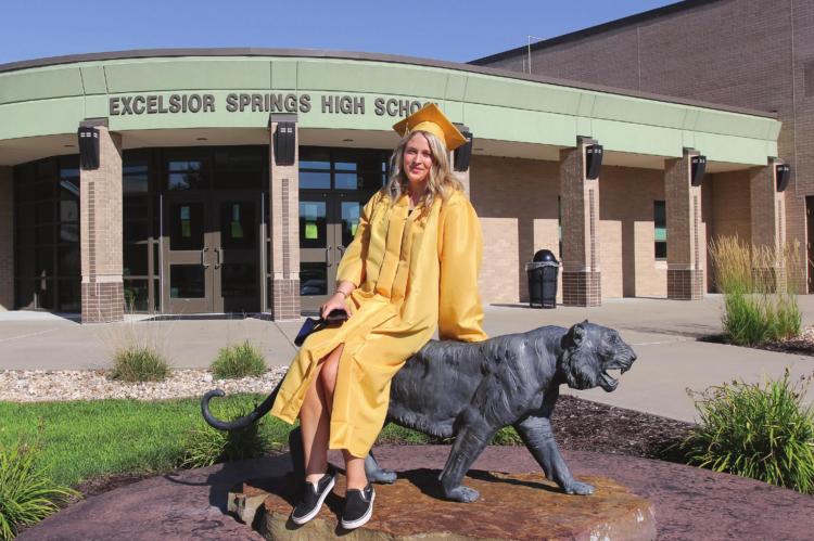 ON GRADUATION DAY, Excelsior Springs High School senior Tori Bryan poses for a photo outisde the high school. The pandemic delays graduation to Aug. 1. J.C. VENTIMIGLIA | Staff