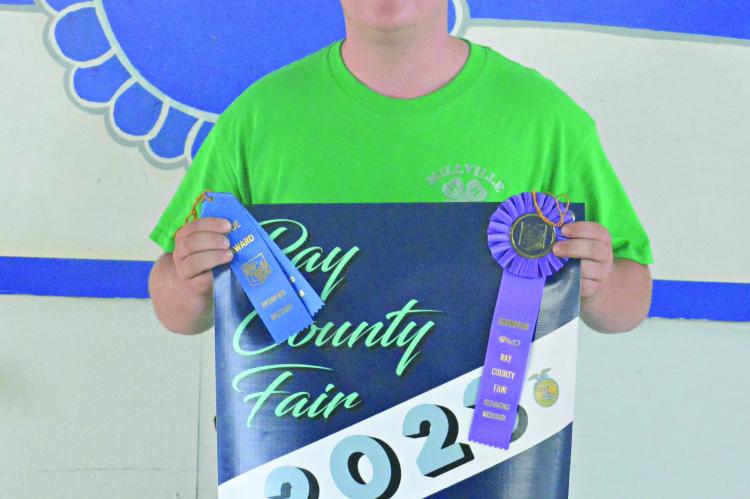 DANTIN McBEE, a student in the Excelsior Springs School District, displays his Best of Show Overall award for shooting sports after finishing the archery competition July 15 at the Ray County Fairgrounds. SHAWN RONEY | Staff