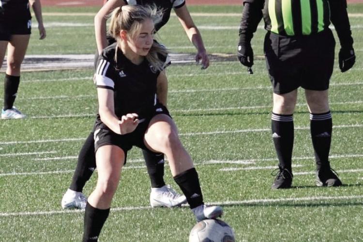 JUNIOR BAILEY CARDER, seen here gaining possession during an Excelsior Springs Tournament game at Tiger Stadium, has provided some of the scoring that has helped the Tigers win five of their last six games. DUSTIN DANNER | Staff
