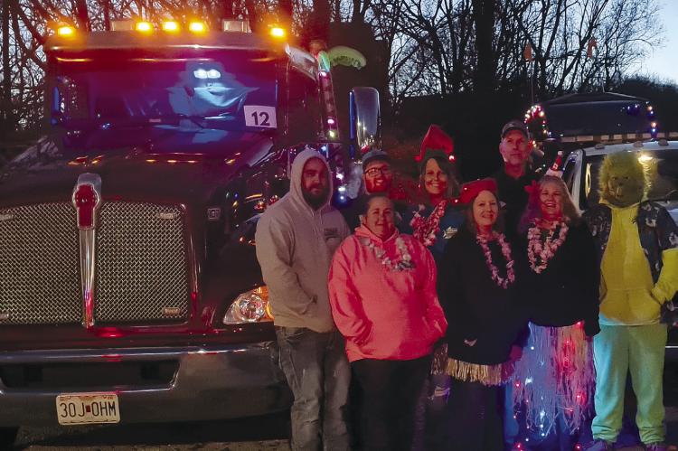 PARSONS TOW &amp; SHOEMAKER TOW get their trucks ready to be in the Christmas Luau Parade. MIRANDA JAMISON | Staff