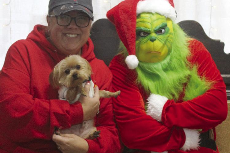 STEPHANIE OAKS brings her dog, Moose, to visit the Grinch.