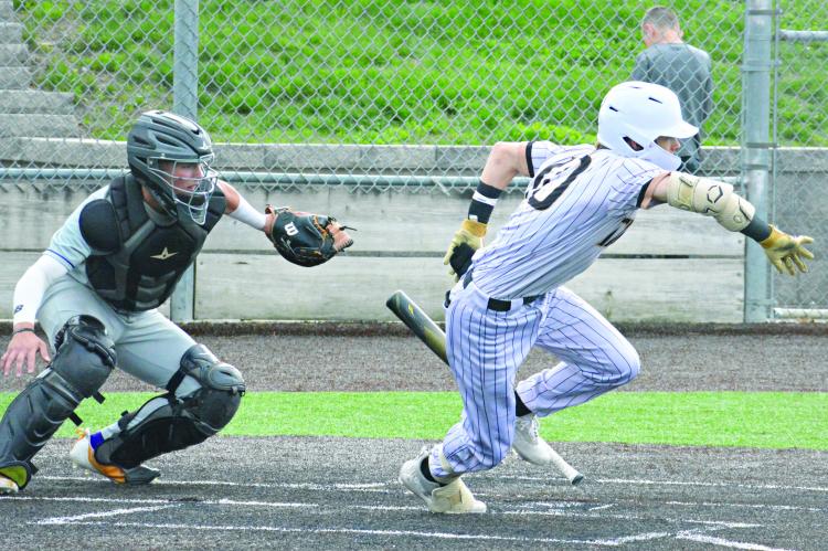EXCELSIOR SPRINGS SOPHOMORE Ryne Marcum promptly drops his bat and bolts toward first base after putting down a bunt during the Tigers’ epic varsity baseball game with Kearney Monday at Tiger Stadium. SHAWN RONEY | Staff