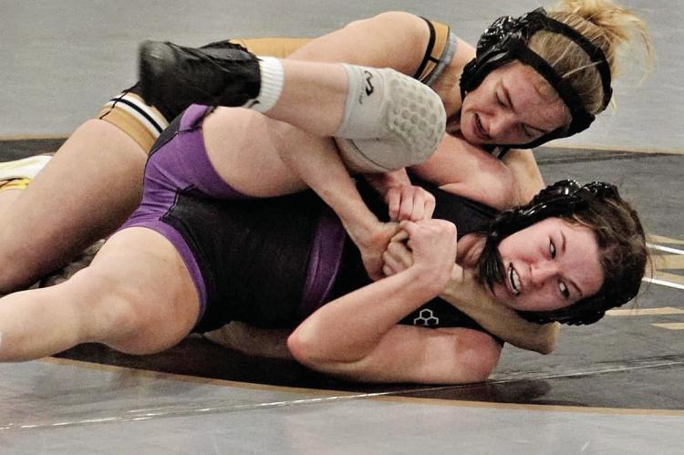 JUNIOR ALYSSA BETTS, top, secures a cradle hold and gets a win by pin in the 125-pound match during Excelsior Springs’ Jan. 11 home dual loss to Kearney. DUSTIN DANNER | Staff
