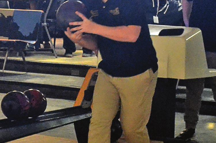 WITH BOWLING BALL in hand, Excelsior Springs sophomore Joshua Oldham eyes the pins at the end of the lane. DUSTIN DANNER | Staff