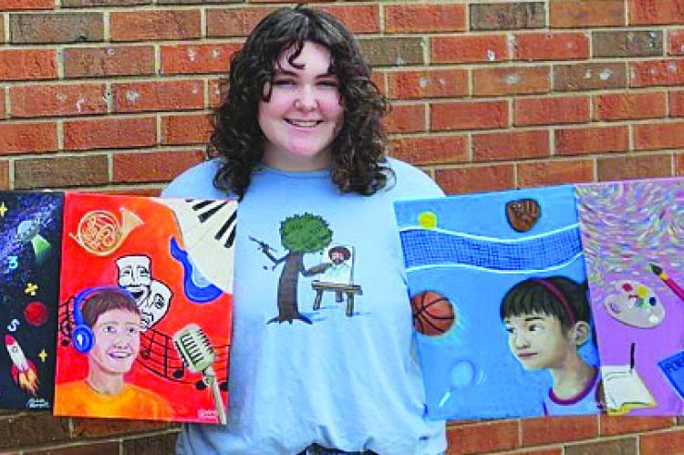 KATELIN MANSELL shows off her four paintings created for the Excelsior Springs School District Office. KATELIN MANSELL | Submitted