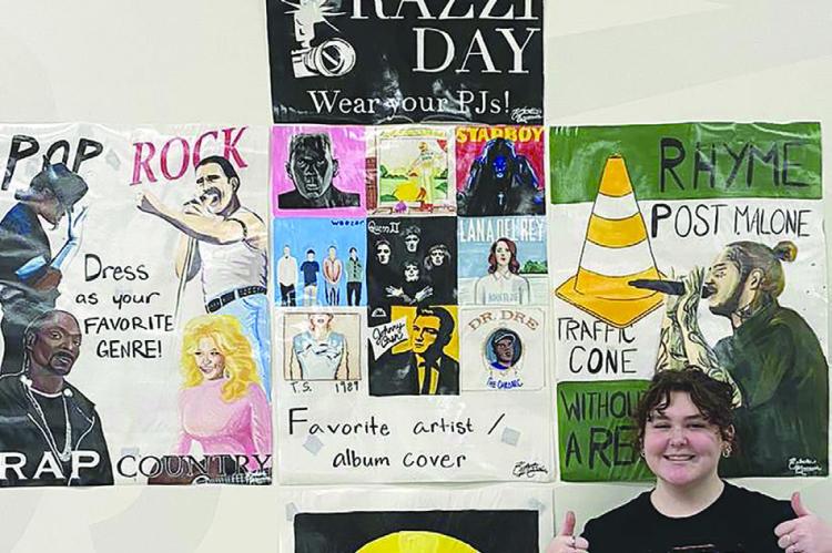 KATELIN MANSELL gives her art work two thumbs up for this year’s homecoming spirit week. KATELIN MANSELL | Submitted