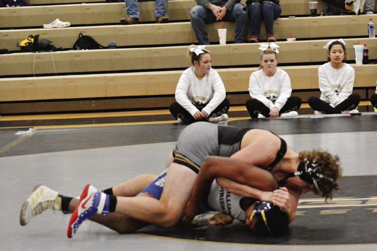 EXCELSIOR SPRINGS sophomore Hunter Scoma, top, works to turn his opponent during a Dec. 7 triangular hosted by the Tigers. DUSTIN DANNER | Staff