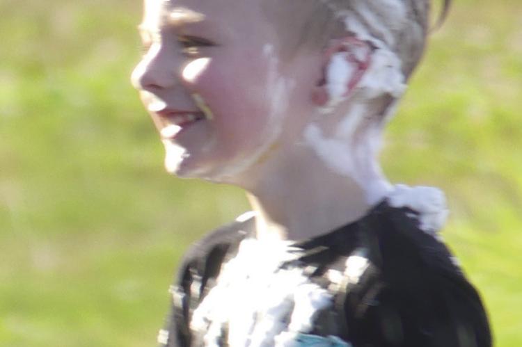 Braxton Watson smiles even while covered in shaving cream.