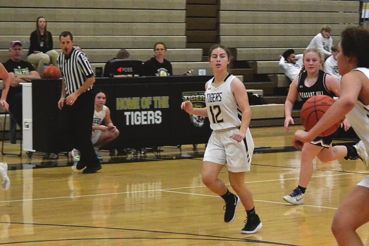 BAYLEE O’DELL, No. 5; Bailey Carder, No. 12; and Ashlon McIntosh look to capitalize on a numbers advantage while running a fast break last week during the Tigers’ 52-49 nail-biting victory over visiting Pleasant Hill. DUSTIN DANNER | Staff