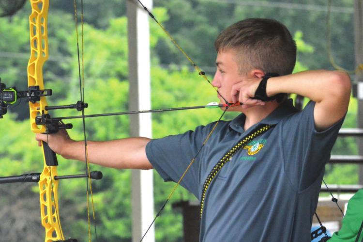 SILAS O’DELL takes aim during archery competition July 16 at the Ray County Fair in Richmond. SHAWN RONEY | Staff
