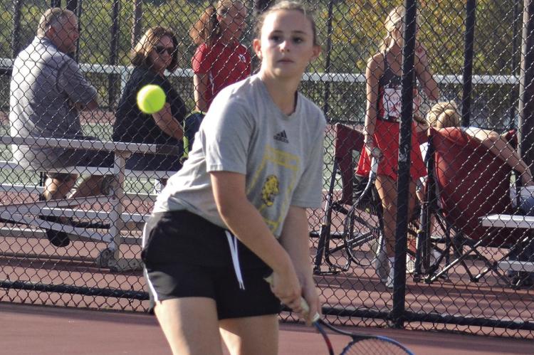 REBECCA McDADE, an Excelsior Springs junior, looks to hit a two-fisted backhand shot Oct. 4 against Carrollton in district play at Excelsior Springs. DUSTIN DANNER | Staff